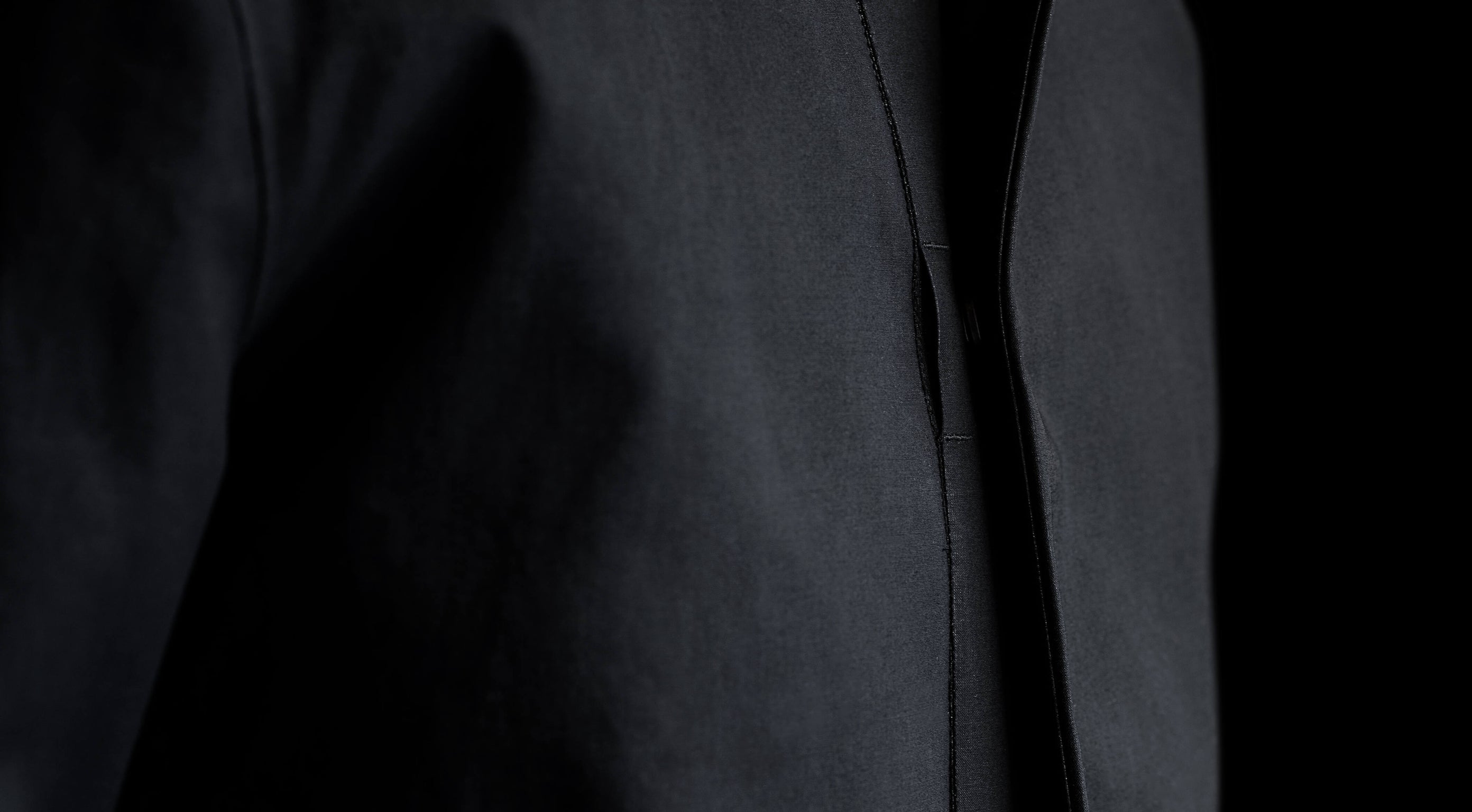 Minimalist chest snap detail with thumb access